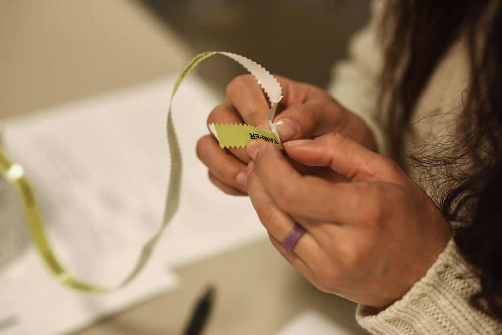 An ER nurse pulls off a piece of evidence tape